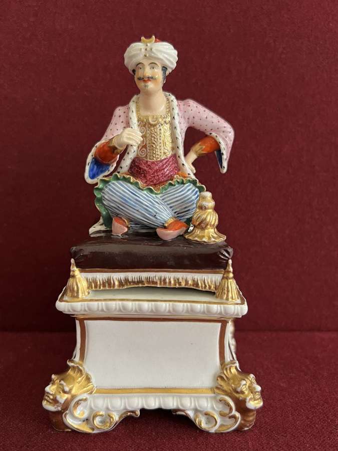 A Bloor Derby Porcelain figure of a seated Turk c.1820